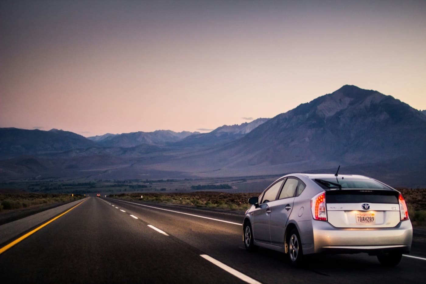 Rideshare-ready hybrid on an Arizona desert highway at dusk